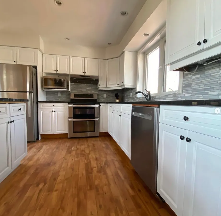 Kitchen with stainless appliances and stone counters