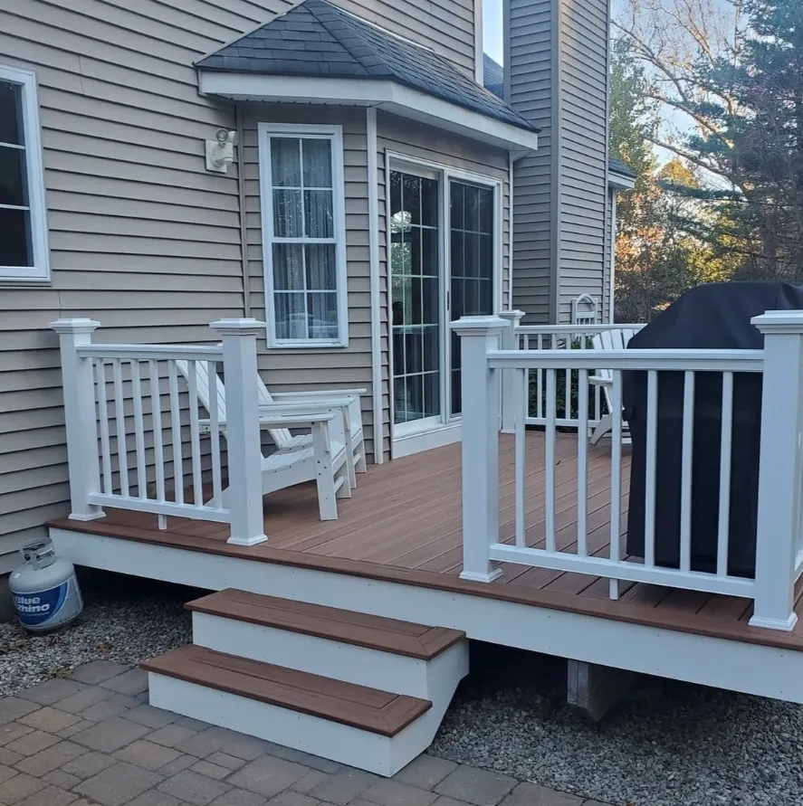 Wood deck with white railings, exterior of home