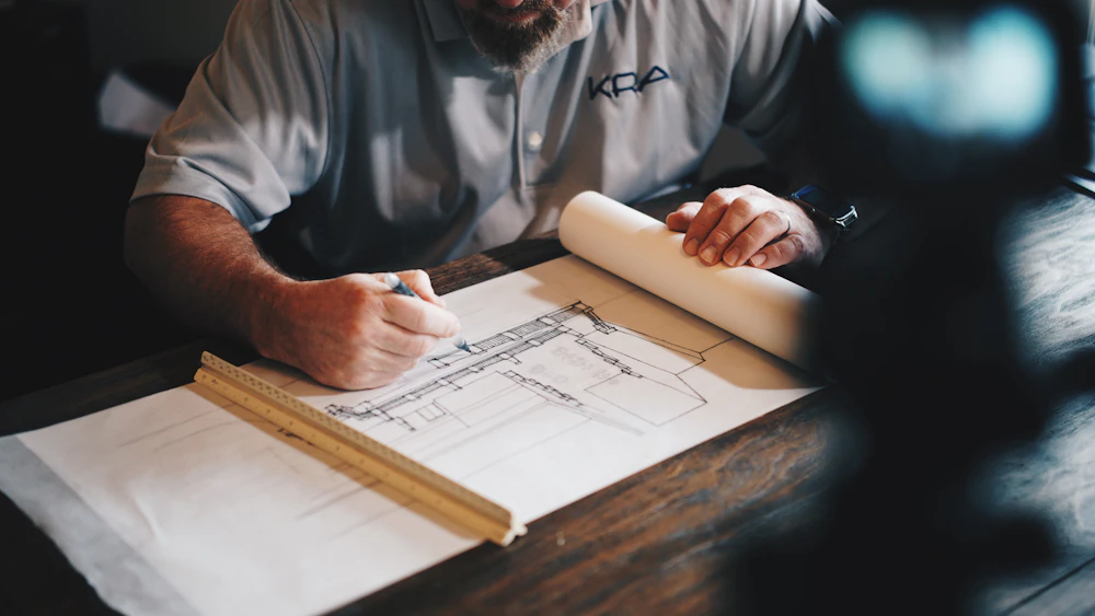 Architectural concept sketches and a blueprint on a desk