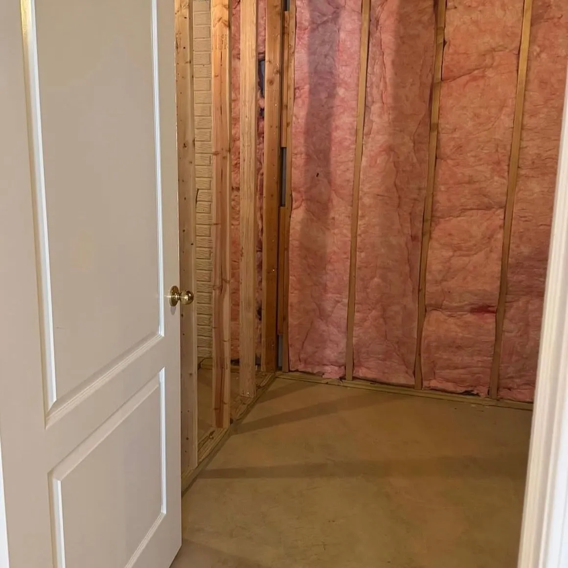 An open stud wall in an Ontario home with wiring and insulation exposed