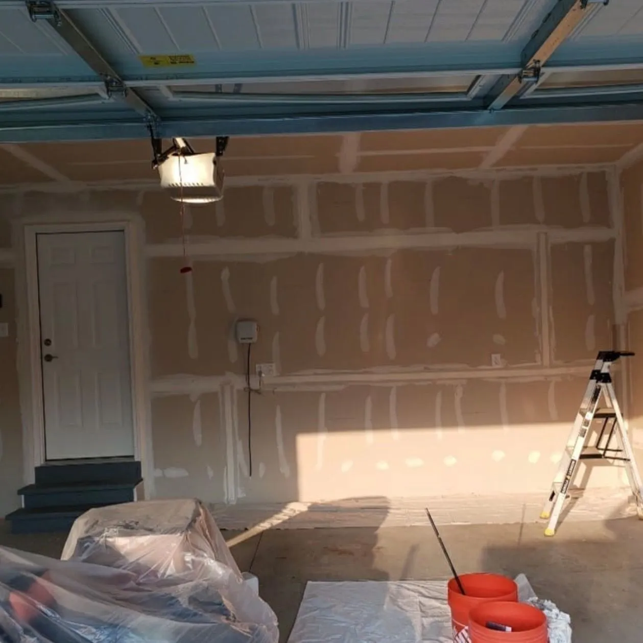A garage being drywalled during a conversion by Zeybek Construction in Ontario