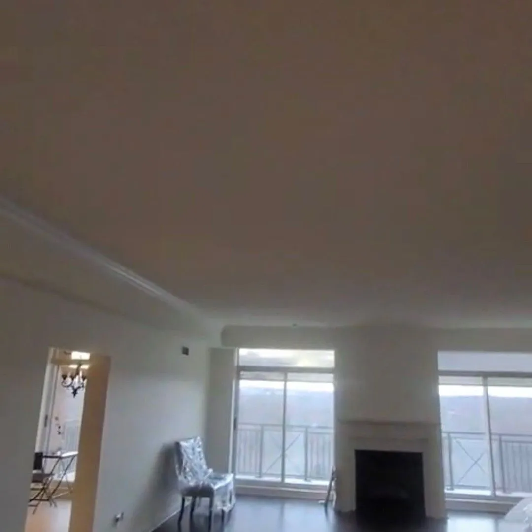 An empty finished room with new windows in an Ontario home by Zeybek Construction