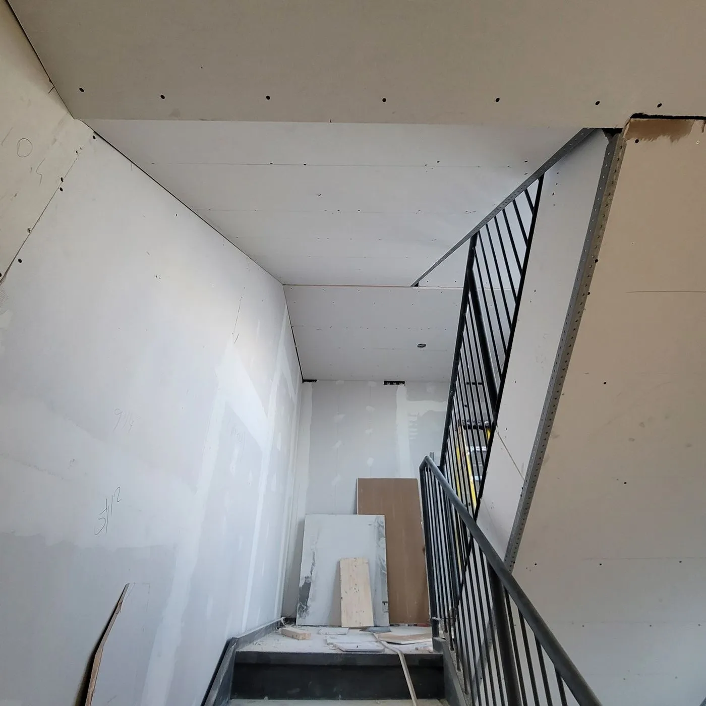 A renovated staircase with iron railings by Zeybek Construction in Ontario